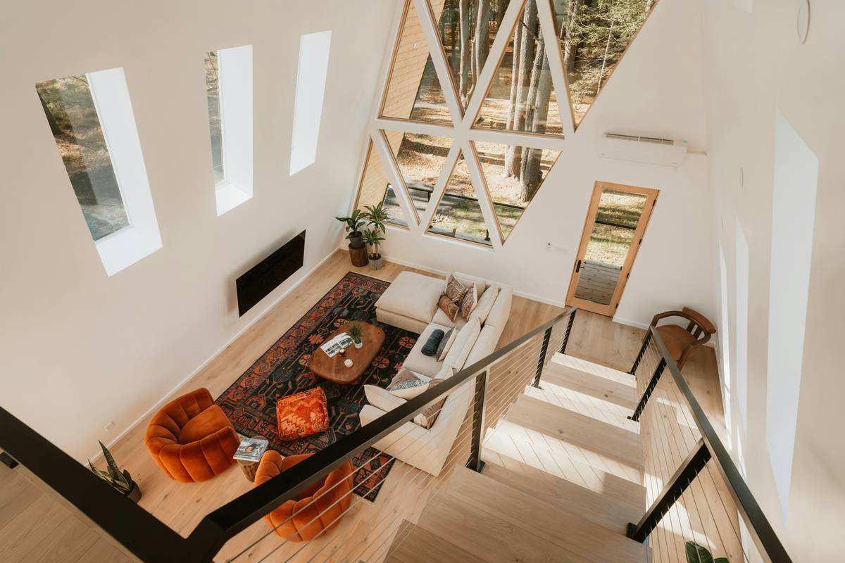 Artistic vacation homes featuring a sunlit living room with original paintings, handmade rugs, and locally crafted furniture
