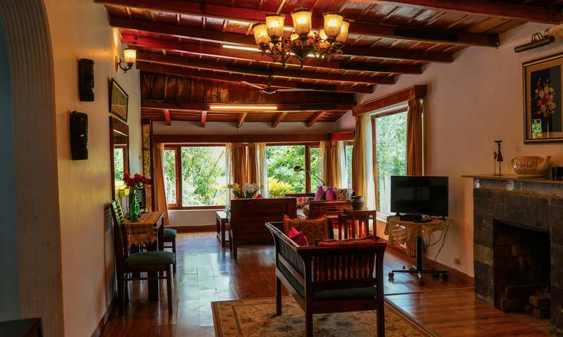 Stylish modern vacation rental with floor-to-ceiling windows, neutral interiors, and outdoor lounge area in a scenic coastal setting